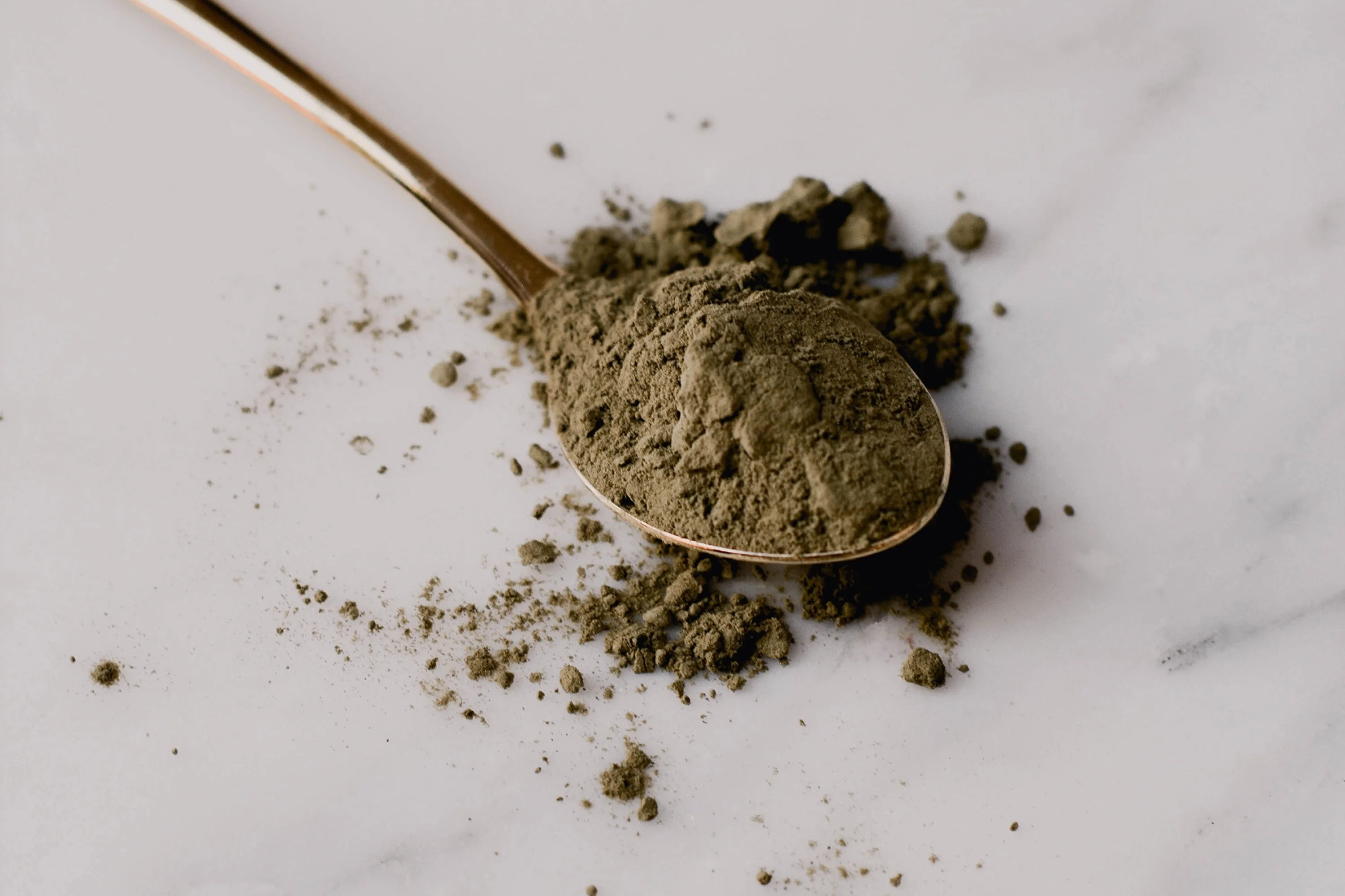 green herbal powder on a spoon